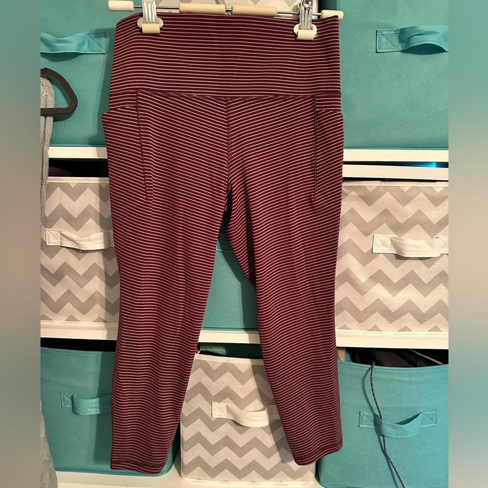 Athleta Salutation Stash 7/8 with pockets Maroon w/ light pink stripe’s.
